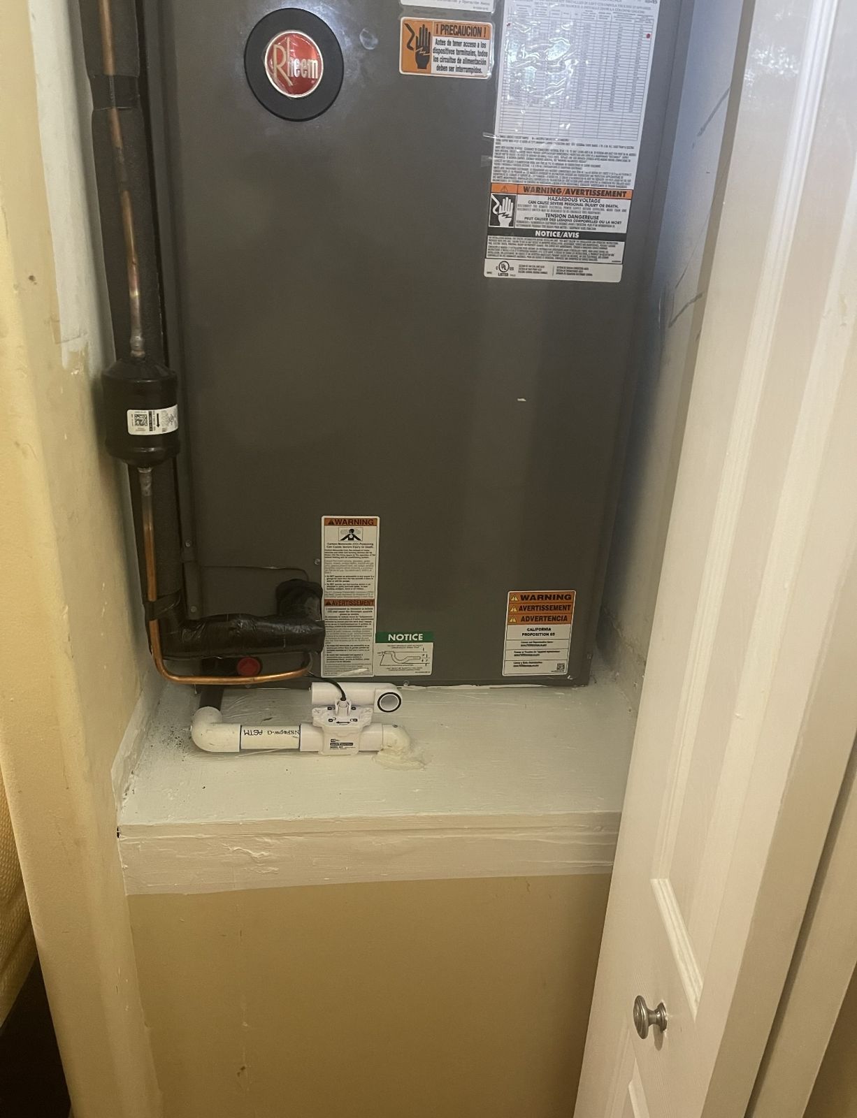 New Rheem air handler on an elevated stand with a secondary drain pan in a Nautica Sound closet, Boynton Beach