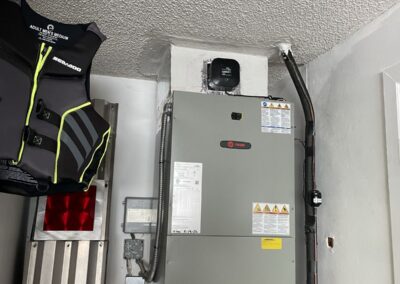 New air handler installed in a garage closet with a condensate line in Wellington