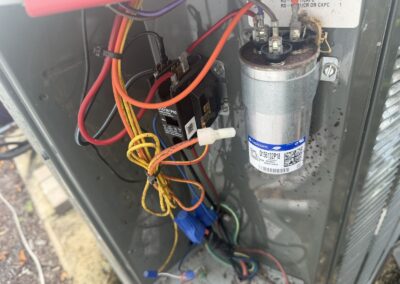 Capacitor and contactor wiring inside an outdoor AC unit during a tune-up in Canyon Trails, Boynton Beach