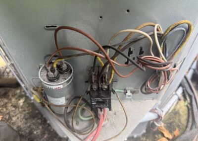 Contactor and capacitor inspected in a condenser electrical compartment in Boynton Beach
