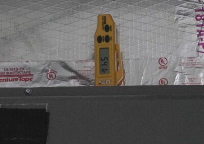 Thermometer probe measuring supply air at an insulated plenum in Boynton Beach