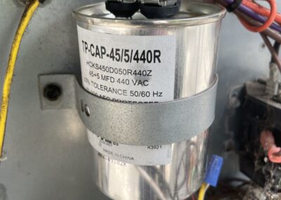 45/5 dual run capacitor being tested in an outdoor AC unit in Boynton Beach