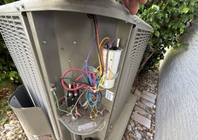 Outdoor AC unit electrical panel open with capacitor and wiring checked in Boynton Beach