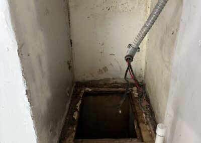 Old air handler stand removed showing the original under-slab drain line in Boca Raton