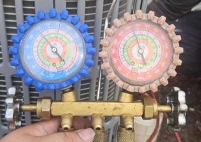 Manifold gauges connected at an outdoor unit after a compressor replacement at a Delray Beach office