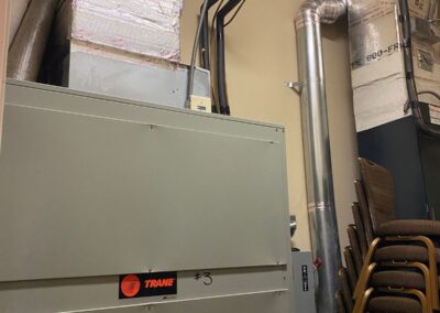 Air handler in a clubhouse mechanical room during a 10-ton system repair in Boynton Beach