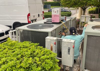 Row of outdoor condensers behind an HOA clubhouse in Boynton Beach