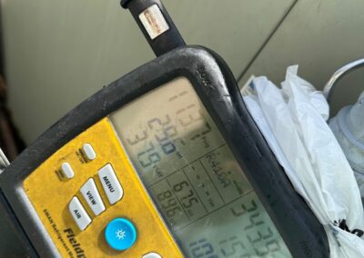 Refrigerant pressure readings on a digital gauge during a commercial AC check in Boynton Beach
