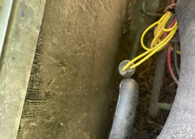 Inside an outdoor AC unit showing the compressor and wiring during a fan motor repair in West Palm Beach
