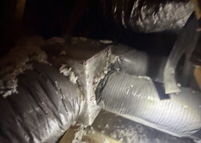 Attic duct junction with taped flex duct connections above a home in Mizner Falls, Boynton Beach