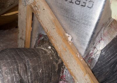 Duct-board distribution box with a sheet-metal collar and flex duct connections in a Wellington attic