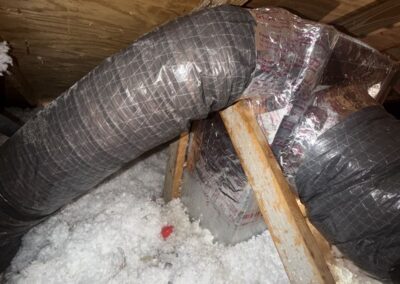 Relocated flex ducts reconnected at a duct fitting in an attic in Wellington