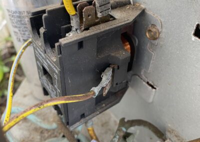Rusted contactor and capacitor wiring inside an outdoor AC unit before replacement in Boca Raton