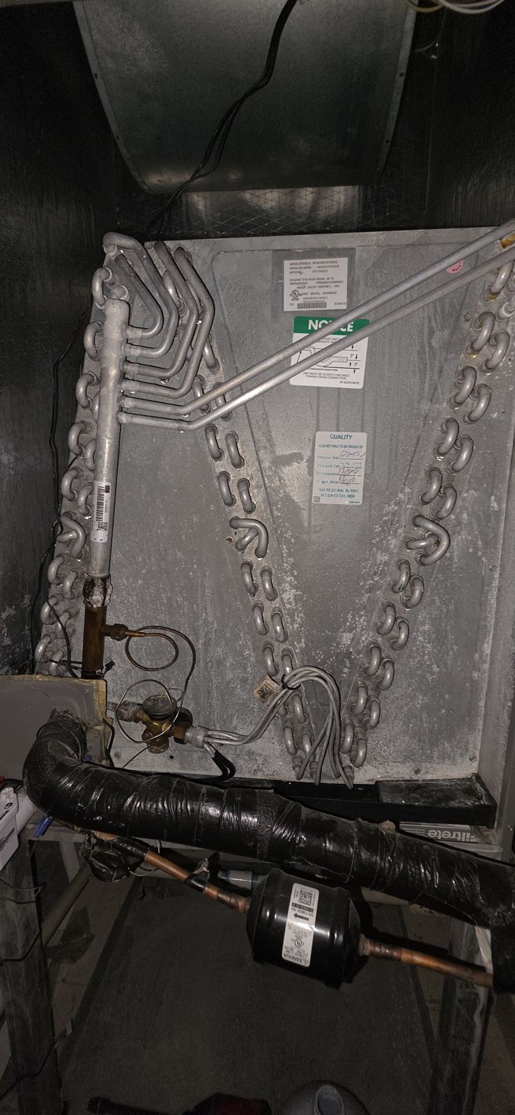 Evaporator coil and refrigerant lines inside an air handler in Canyon Trails, Boynton Beach
