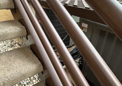 Outdoor AC condenser at the base of a condo stairway in Indian Springs, Boynton Beach