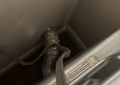 Flexible dryer vent duct behind a dryer in a Boynton Beach condo