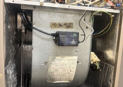 Green UV system ballast mounted on the blower housing inside an open air handler in Valencia Pointe, Boynton Beach