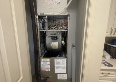 Air handler in a closet with the front panel off after a Green UV light install in Valencia Pointe, Boynton Beach